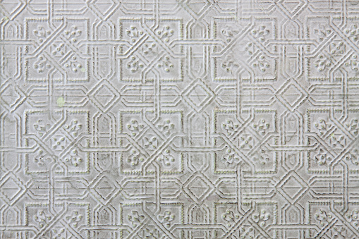 Textured pattern in pressed tin with pale green imperfections
