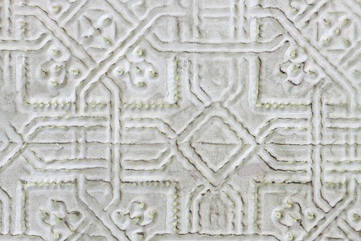Textured pattern in pressed tin with pale green imperfections
