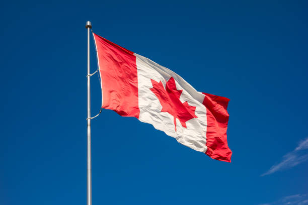 istock Canadian flag against blue sky 1091050488