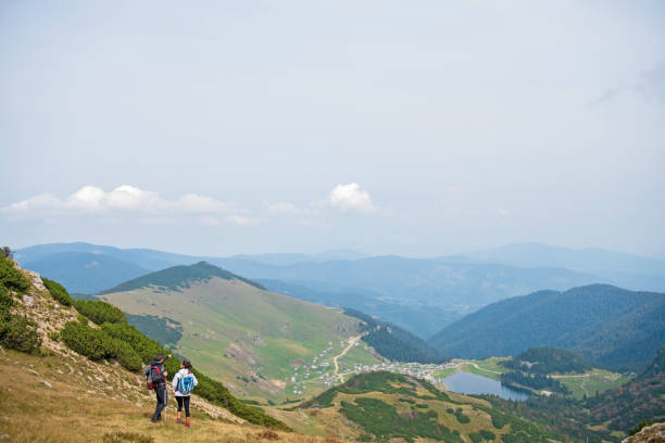 istock Sporty hikers on path with trekking poles 1091050530