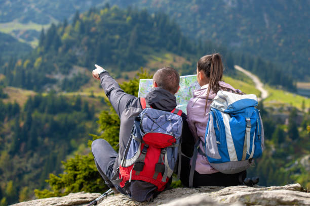 istock Smiling adventure couple with map on slope. look at map 1091057646