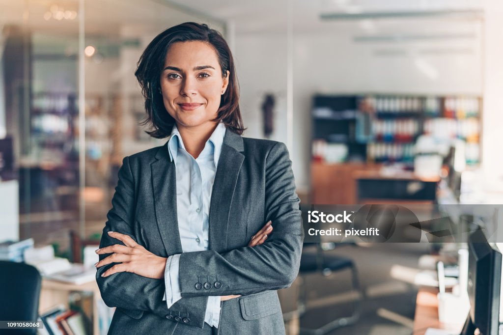 Businesswoman Portrait of a smiling young businesswoman in the office Women Stock Photo