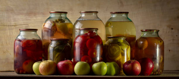istock Home-made canned compote and fresh fruit on the basement shelf still life 1091061048