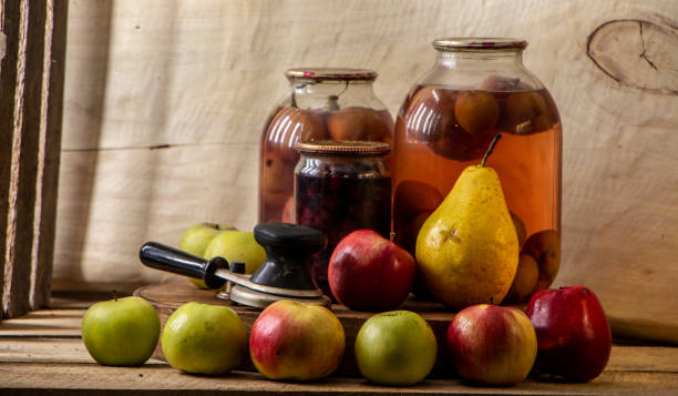 istock Home-made canned compote and fresh fruit on the basement shelf still life 1091061054