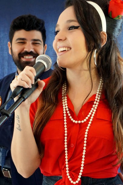 portrait of retro/pin up couple singing and playing guitar