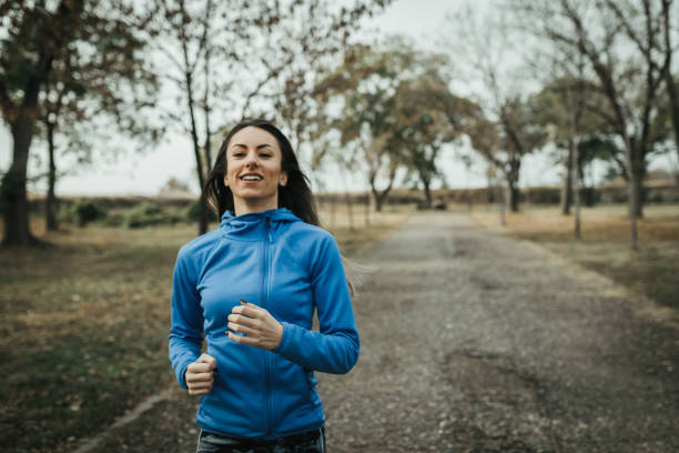 istock Young woman running in the public park 1091067256