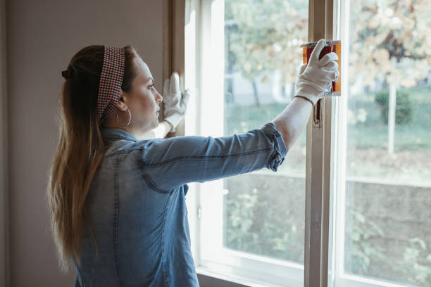 istock Young woman fixing windows at her home 1091068518