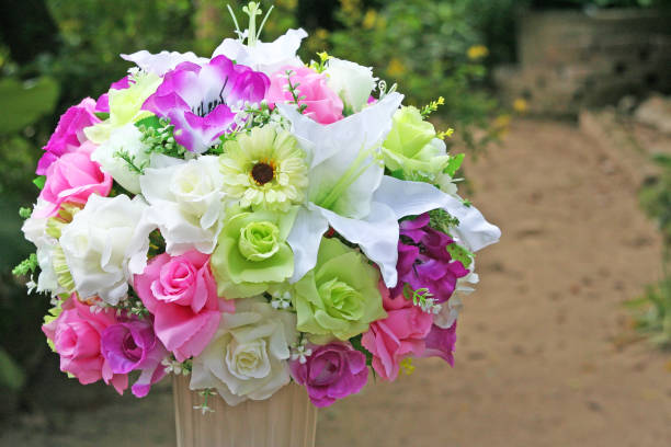 istock Beautiful muticolored artificial flowers in white vase 1091070766