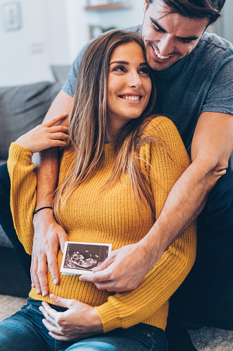 Young happy Couple with baby ultrasound photo