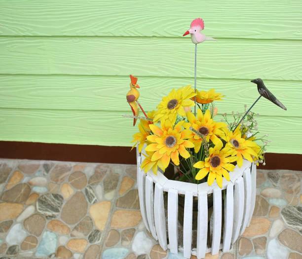 Artificial sunflower and tree bird in  white wood pot