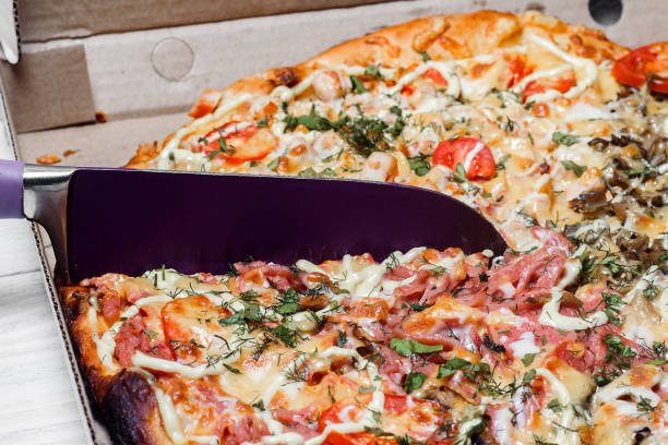 istock Pizza in a cardboard box. Shut. Pizza delivery. Pizza menu. Knife cuts pizza 1091079864