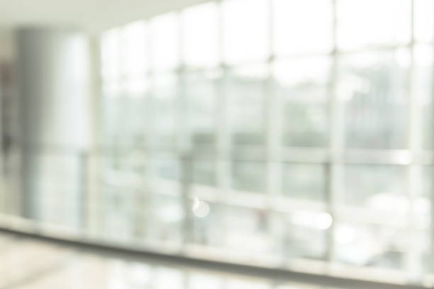 istock Blur background interior view looking out toward to empty office lobby and entrance doors and glass curtain wall 1091081266