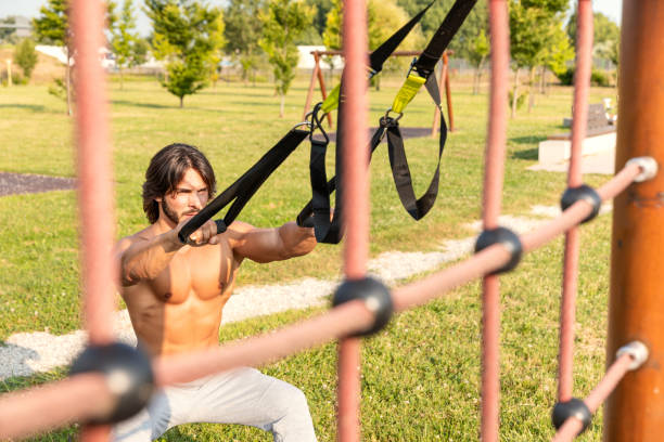 istock Fit young man exercising with suspension trainer 1091082632