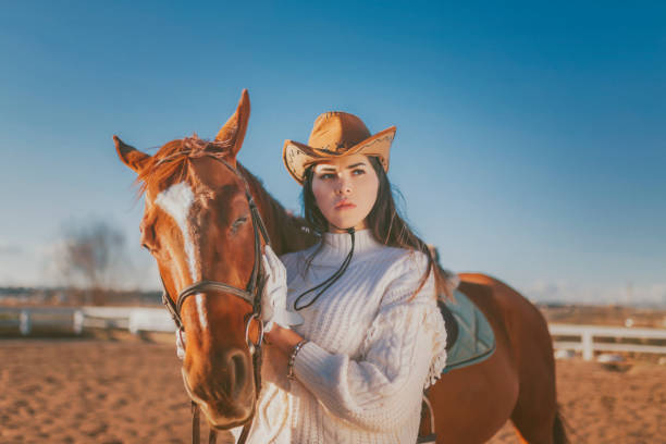 istock woman posing in front of horse 1091086738