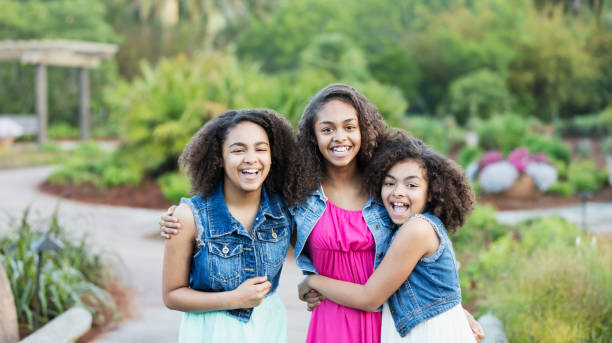 istock Three African-American sisters at a park 1091106932