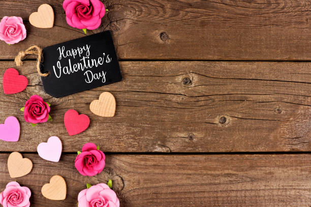 istock Happy Valentines Day side border with gift tag, hearts and roses against rustic wood 1091106964