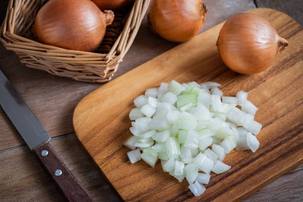 istock Fresh chopped onions on wooden cutting board 1091117728