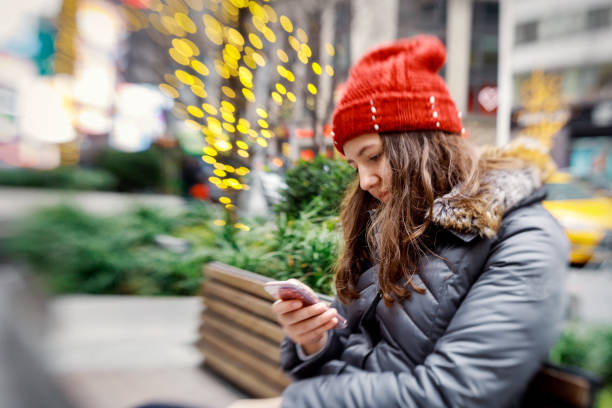 istock Girl walking and texting on her smartphone 1091121934