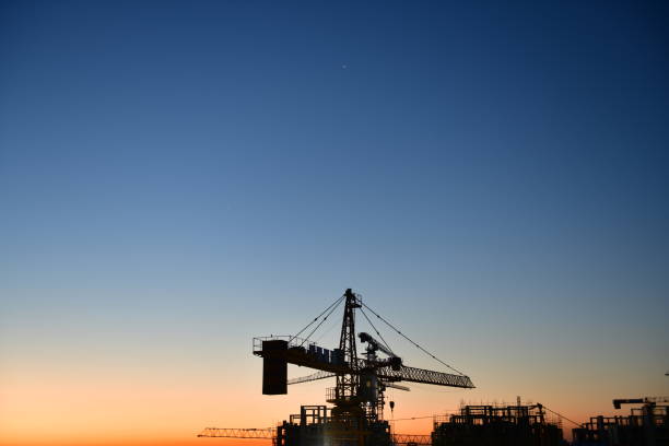 Construction site at dusk evening yellow back light, crane
