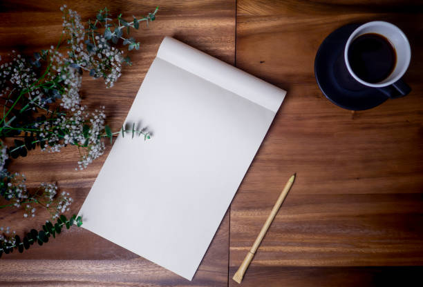 istock Flat lay of blank white notebook with cup coffee on wooden table. 1091146916