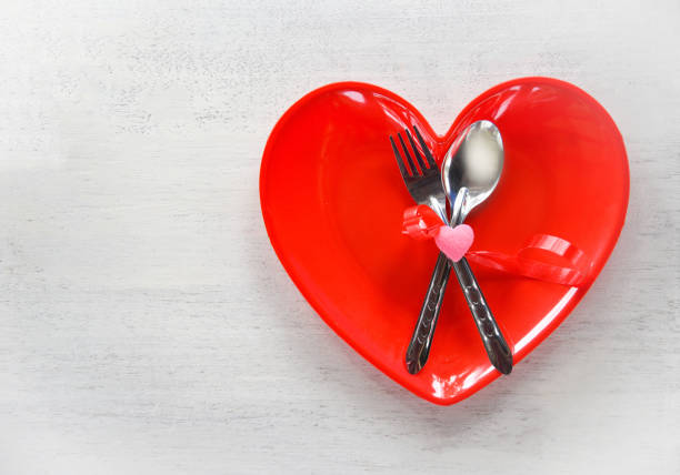 istock Valentines dinner romantic love food and love cooking concept Romantic table setting decorated with fork spoon in red heart plate 1091149122
