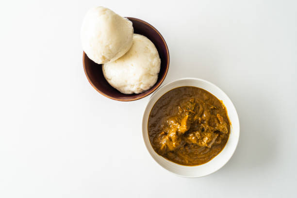 istock Nigerian Pounded yam wrapped in plastic served with Banga Soup 1091151470