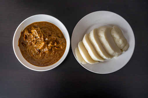 Nigerian pounded yam sliced served with banga Soup a traditional Nigerian Meal