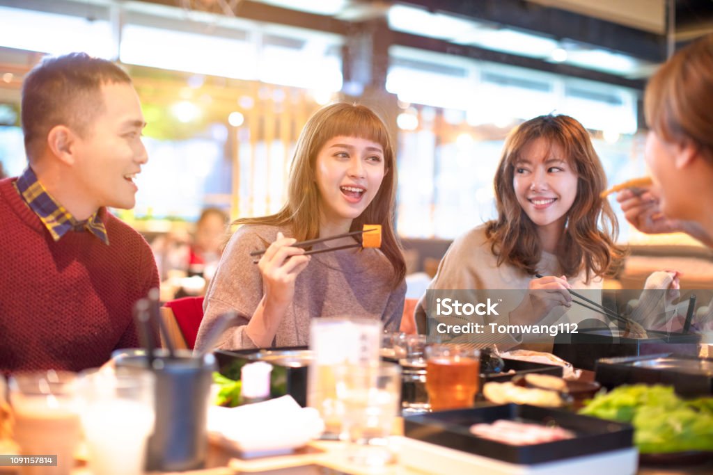 happy asian young Group  eating in the restaurant Asian and Indian Ethnicities Stock Photo