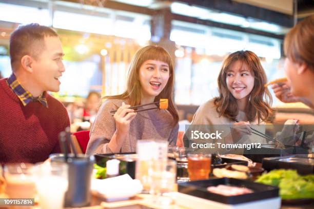 Happy Asian Young Group Eating In The Restaurant Stock Photo - Download Image Now - Asian and Indian Ethnicities, Eating, Restaurant