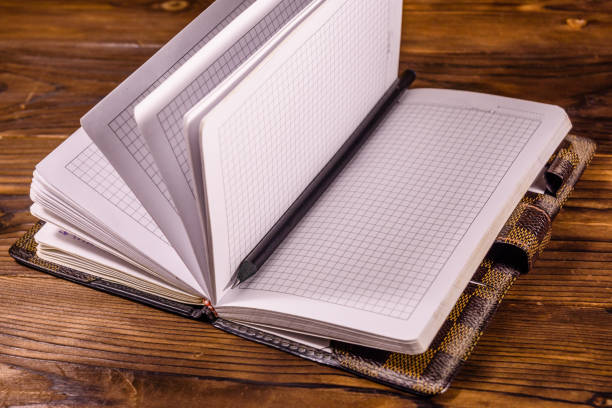 istock Opened notepad and pencil on wooden table 1091158008