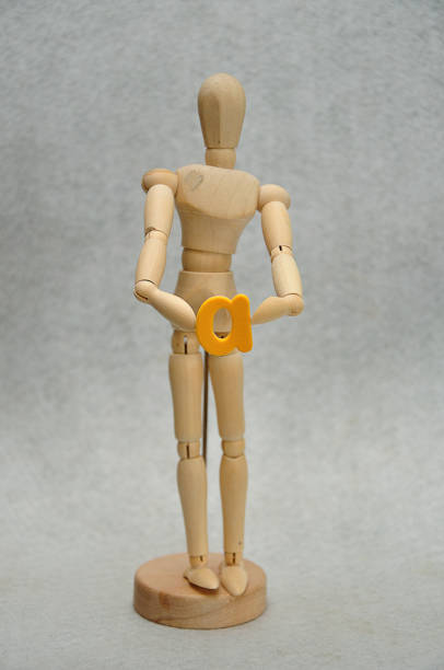 istock A wooden mannequin holding a letter a 1091163882