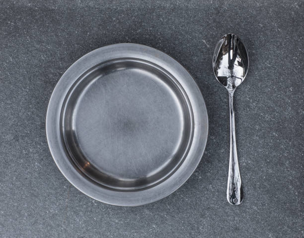 istock metal kitchen plate on gray concrete background,prison plate 1091167188