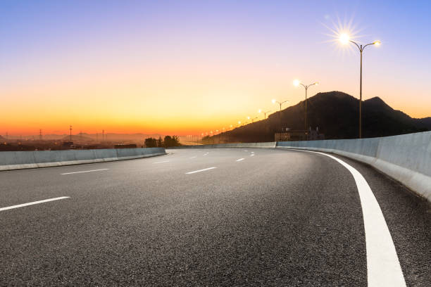 istock Asphalt road and mountains at beautiful sunset 1091171546