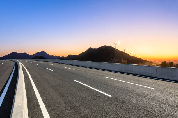 istock Asphalt road and mountains at beautiful sunset 1091171622