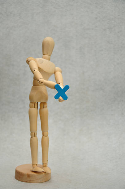 istock A wooden mannequin holding a letter x 1091171730