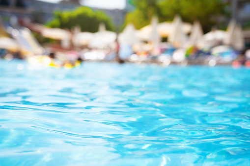 Pool water on blurred background of resort hotel beach
