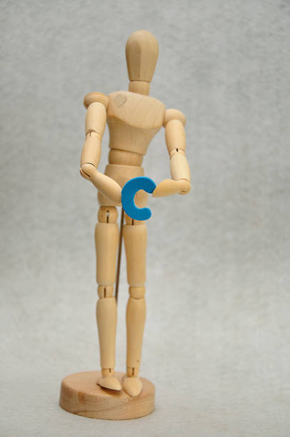 istock A wooden mannequin holding a letter c 1091173862