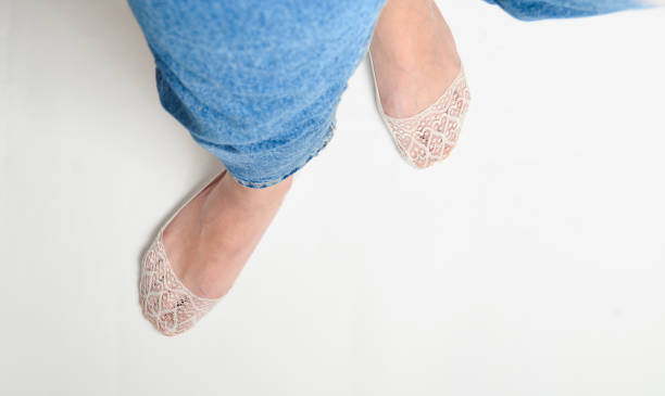 istock Female foot in thin socks on a white background, top view 1091186564