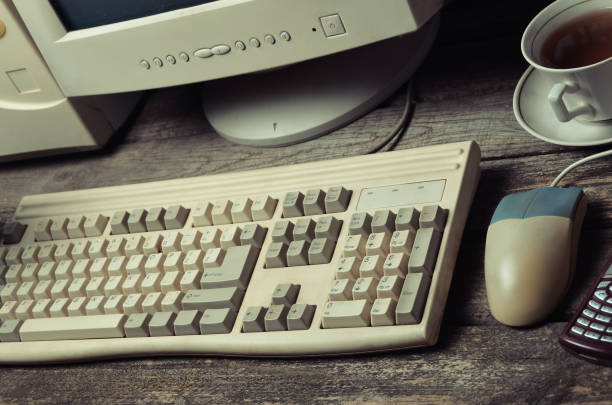 istock Retro stationary computer on a rustic wooden table, vintage workspace, top view, flat lay 1091188896