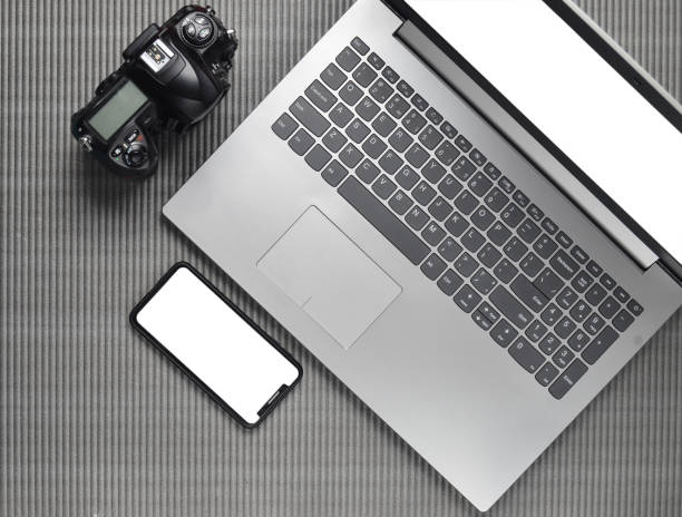 istock Laptop, frameless phone with white screen, camera on a gray texture surface, top view, copy space 1091189330