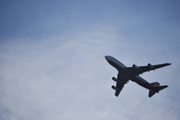 istock Large Airplane in Hazy Blue Sky 1091189852