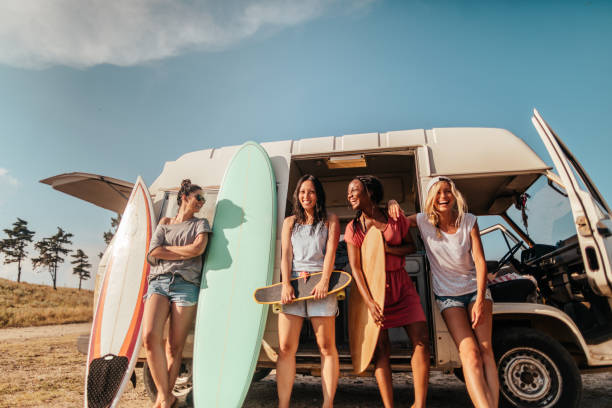 Summer adventure with my girlfriends Smiling girlfriends standing by van at the beach, ready for summer activities happy car asian stock pictures, royalty-free photos & images