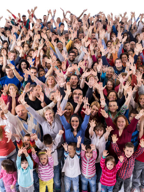 istock Cheerful group of people with arms raised looking at camera. 1091198016