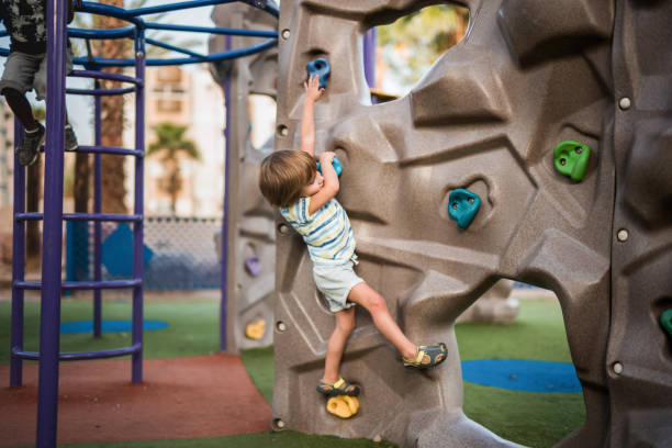 istock Little boy climbing on the wall on the playground. 1091198336