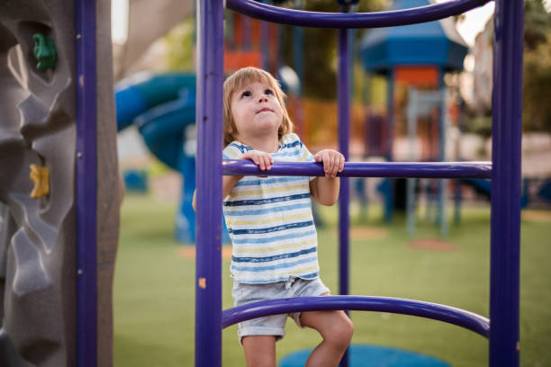 istock Small kid climbing up the ladder on the playground. 1091198370