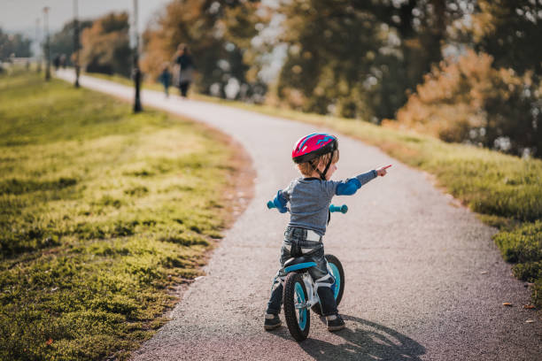 istock Small boy on bicycle pointing at something in the distance. 1091201028