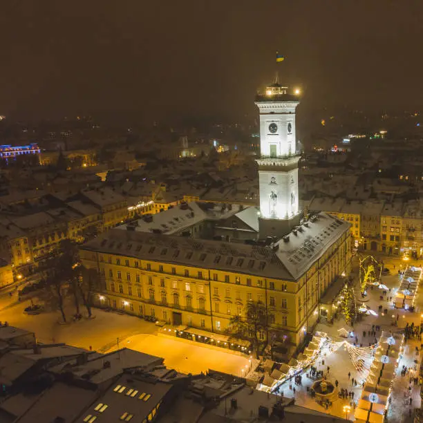 Photo of aerial view of capital building in center of european city at sunset in winter time
