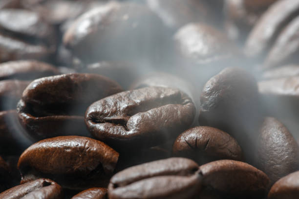 istock Heap of roasted coffee beans with smoke 1091209998
