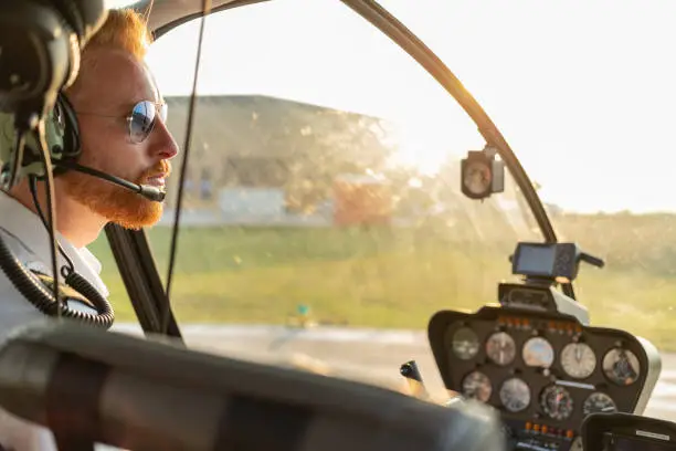 Photo of Aerial view of helicopter pilot welcoming passengers