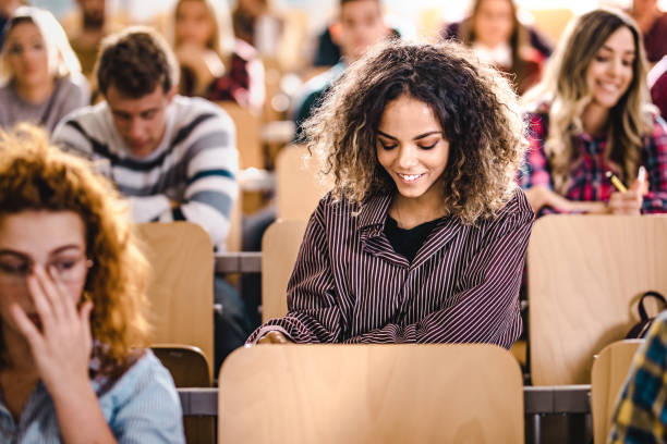 istock Young happy student on a class in the classroom. 1091219306